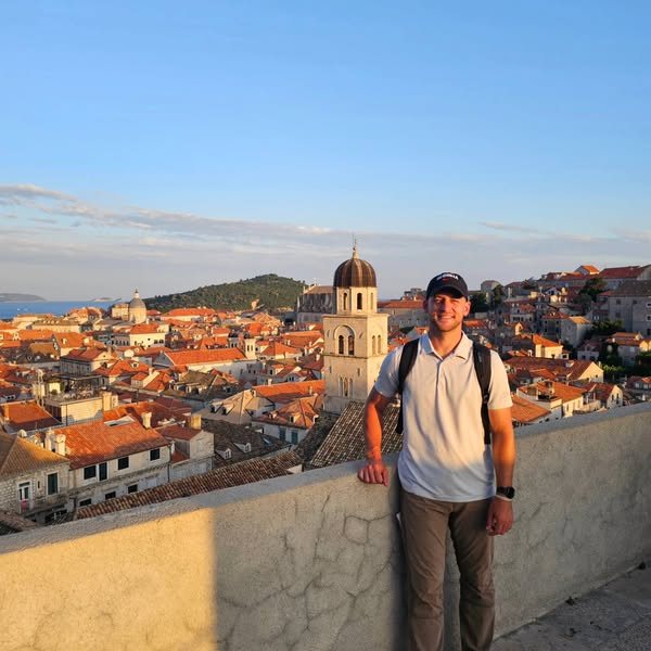 Tyler Woodall on the city walls above the rooftops of Dubrovnik, Croatia
