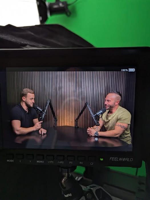 Tyler Woodall recording a podcast interview in a studio